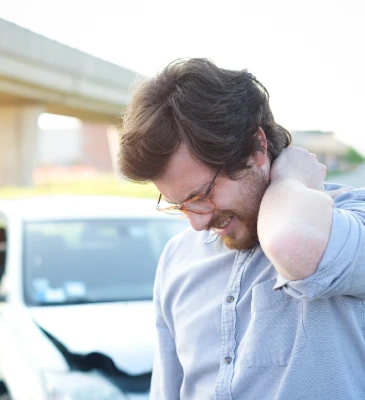 a man standing next to a crashed car